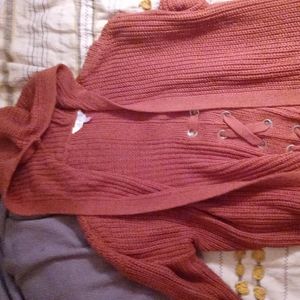Rust colored long sweater with pockets and a hood
